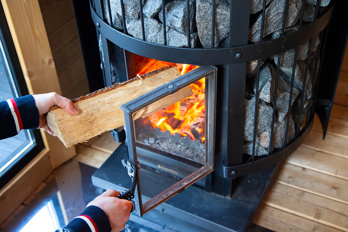 Do wood sauna stoves require a chimney or ventilation system?